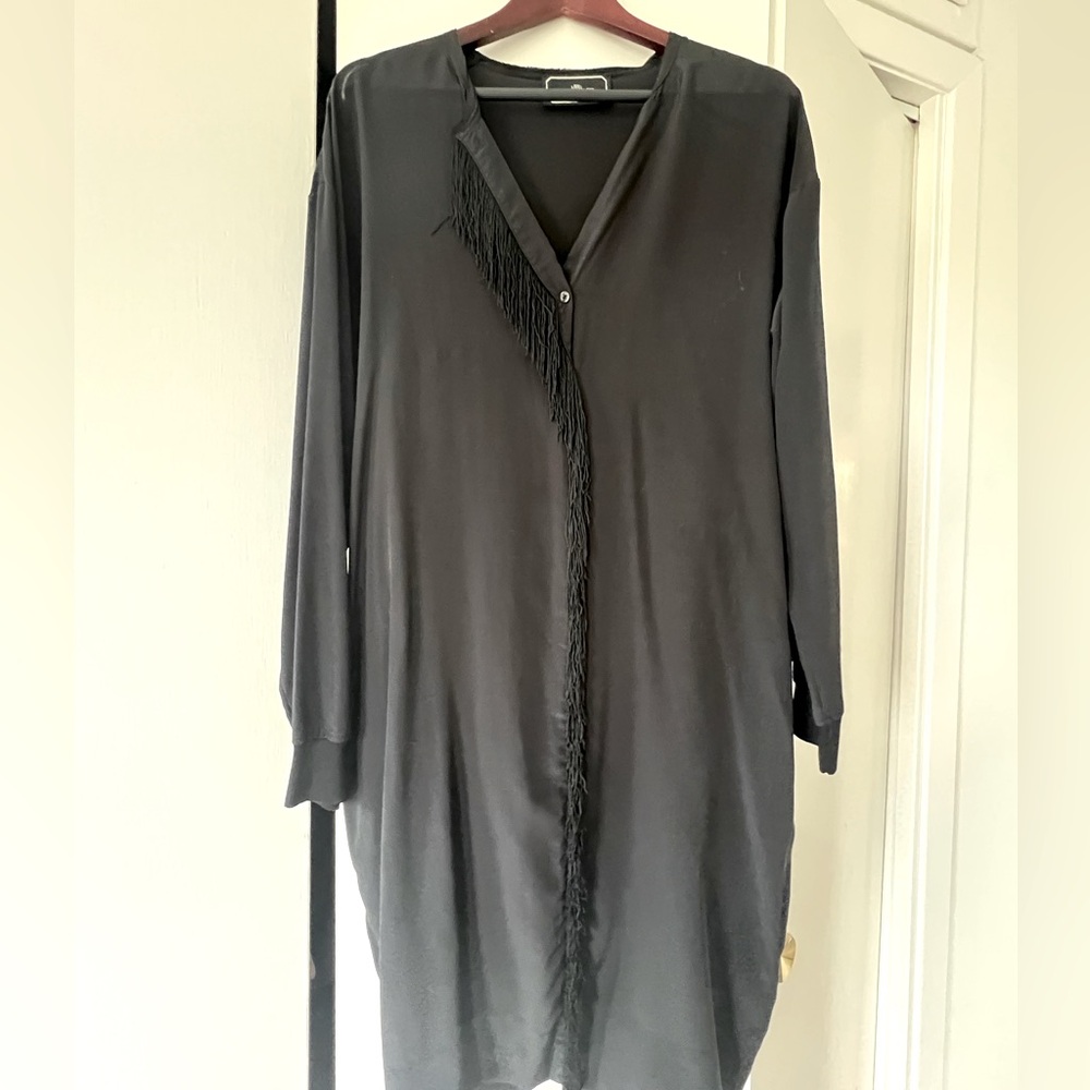 100% silk black dress w/ fringe detail. Looks great with a cinched belt.
